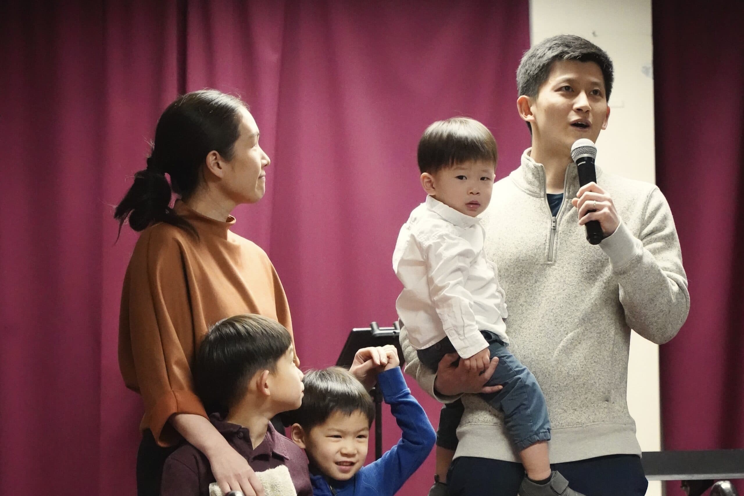 A family on stage with their children during a Metro service