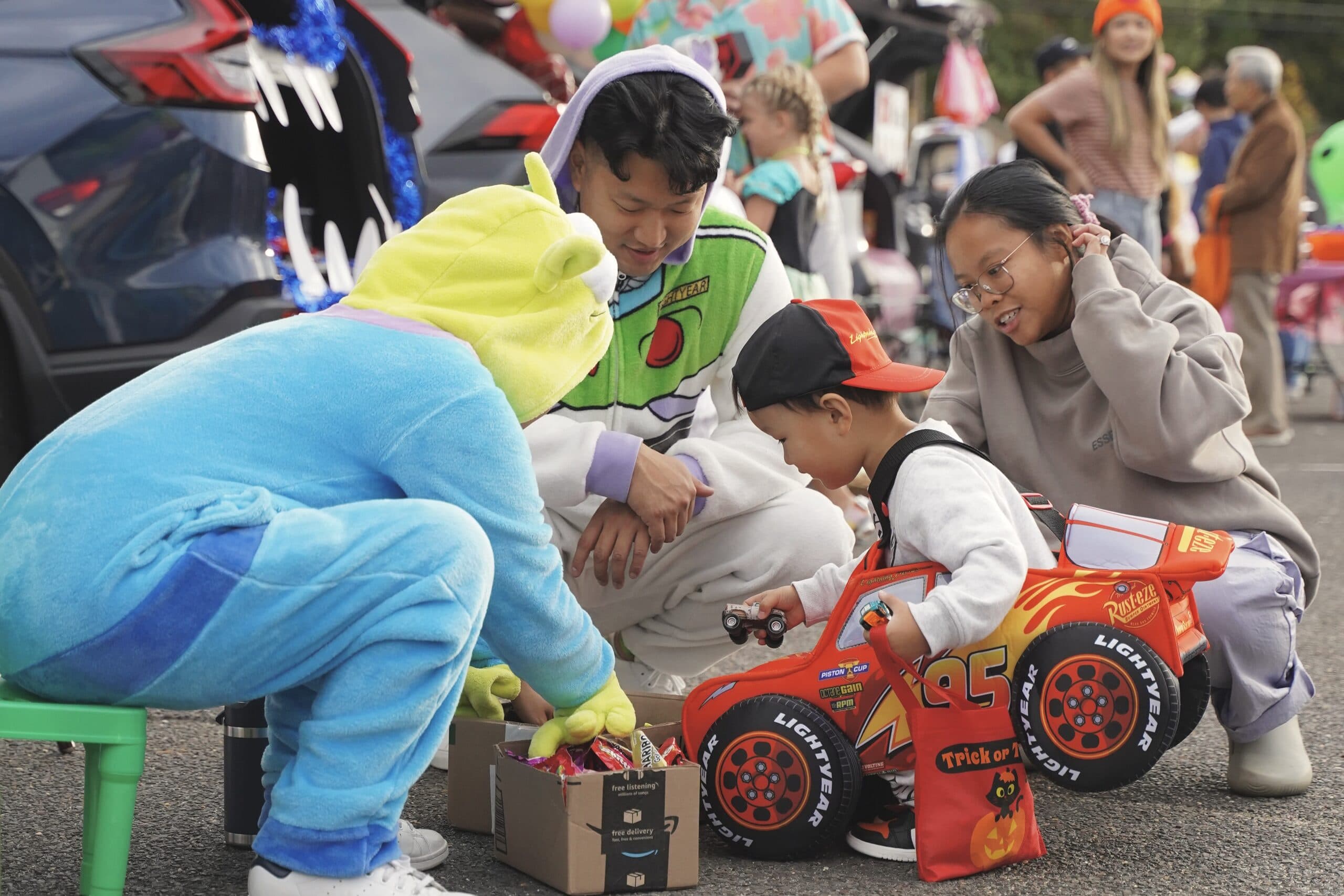 Families and volunteers in costume at Metro's Trunk or Treat